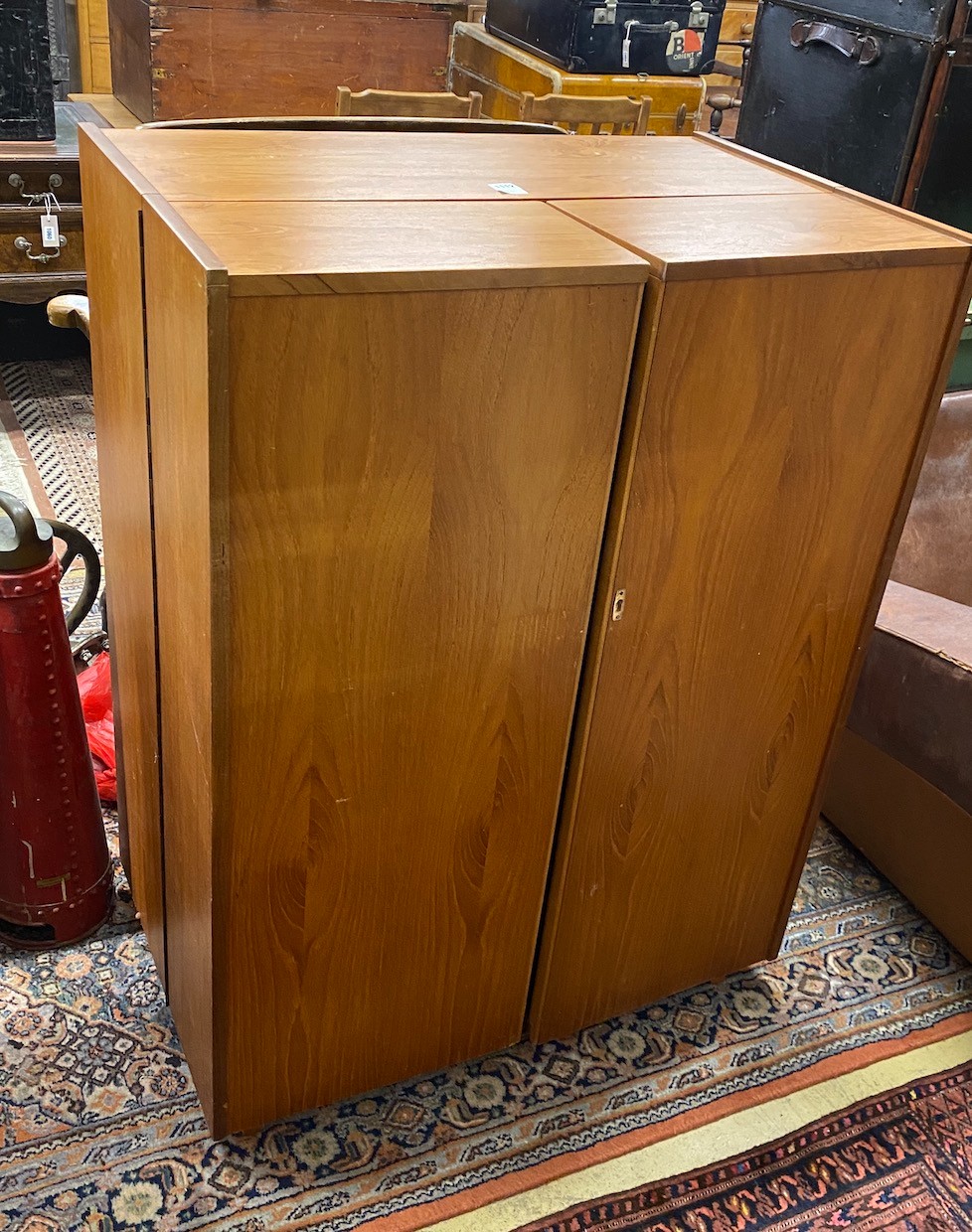 A mid century teak “Magic Box” enclosed desk possibly by Mummenthaler & Meier, Switzerland, interior with pull out drop flap writing surface, dimensions closed width 84cm, depth 54cm, height 112cm